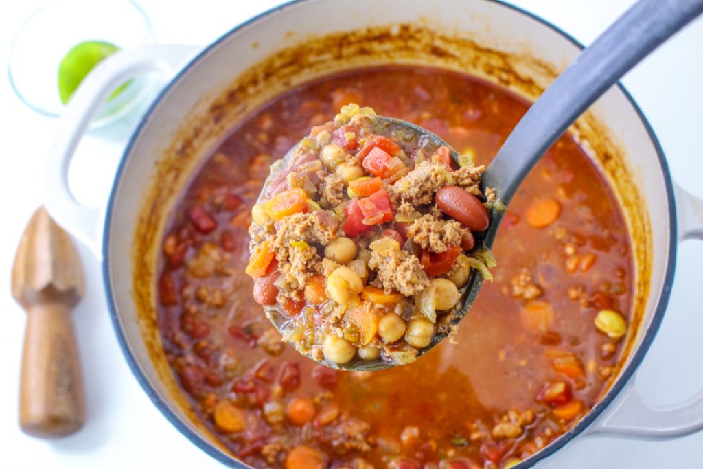 A ladle full of homemade chili.