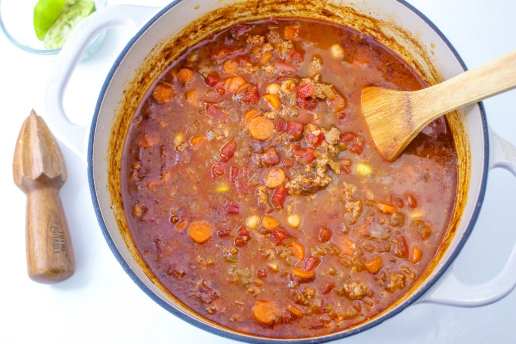 Chili simmering in a large Dutch oven. 