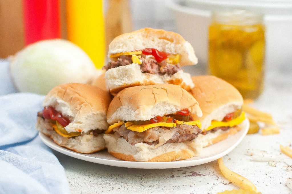 A plateful of mini sliders made with hamburger. 