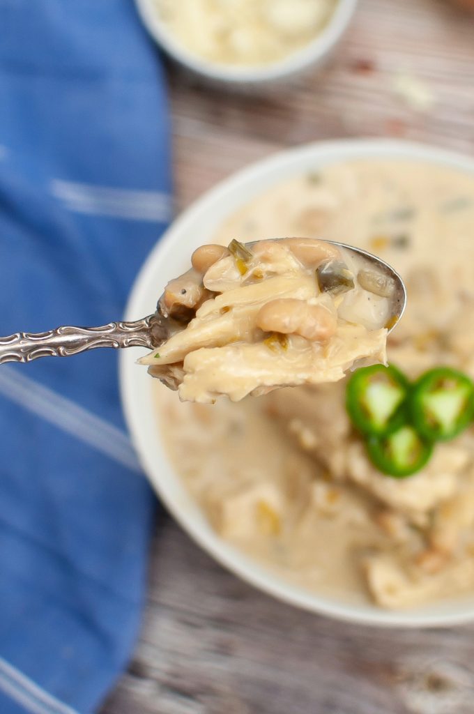 A spoonful of chili with white beans. 