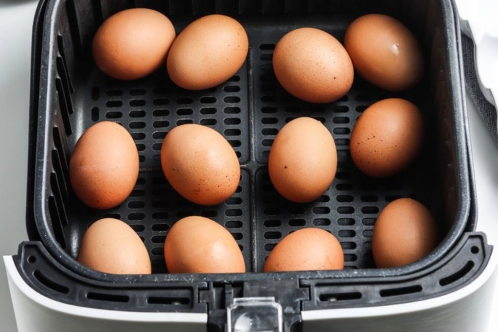 Eggs placed in an air fryer basket.