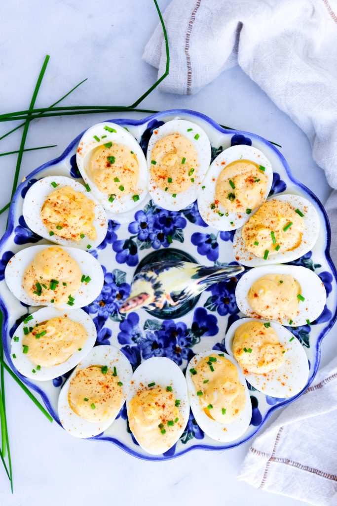 Top view of deviled eggs in a blue ceramic egg holder.