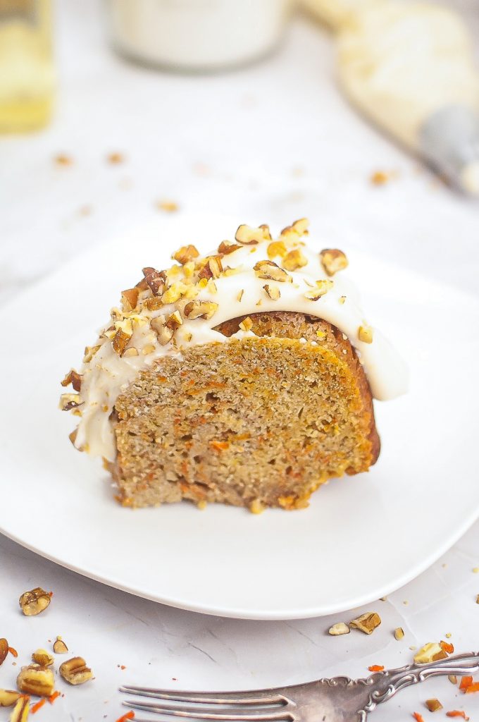 A slice of carrot cake bunt cake on a white plate. 