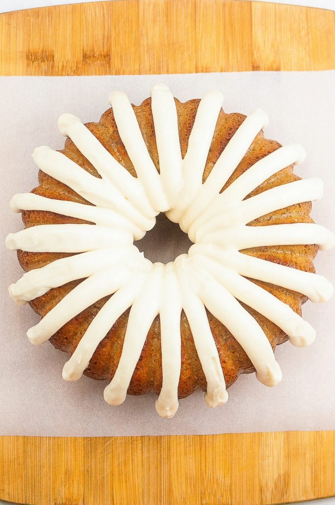 Cream cheese frosting on on a cooled carrot cake. 