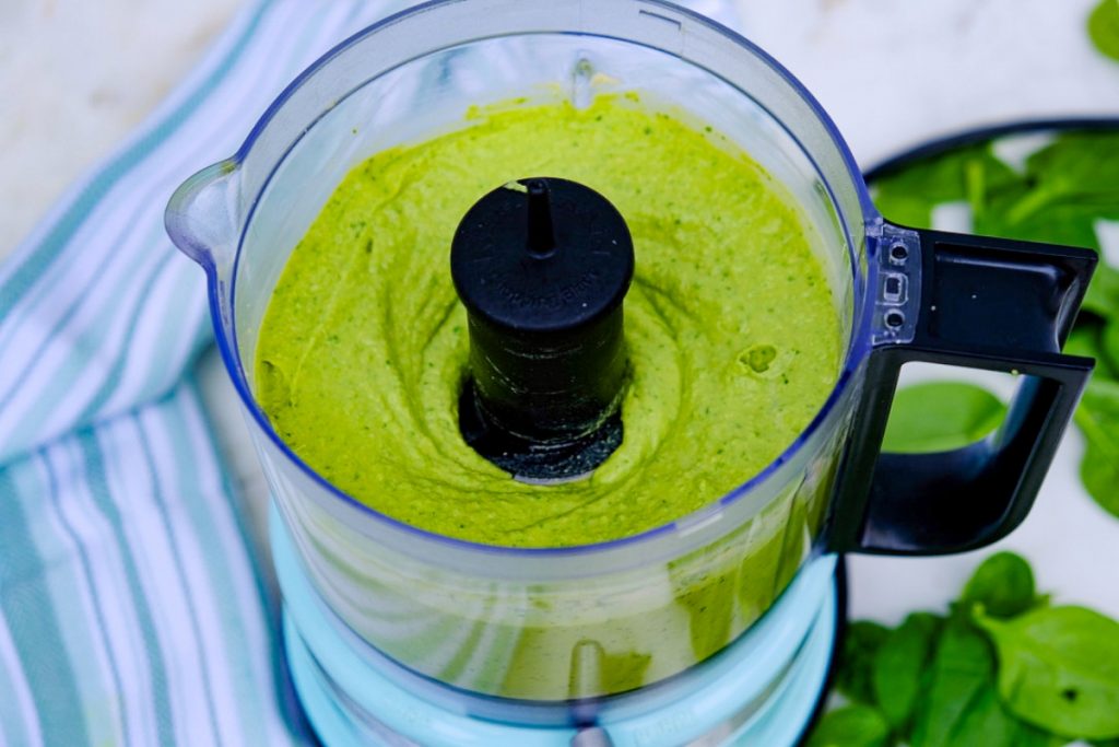 Blended hummus with spinach in a small food processor.