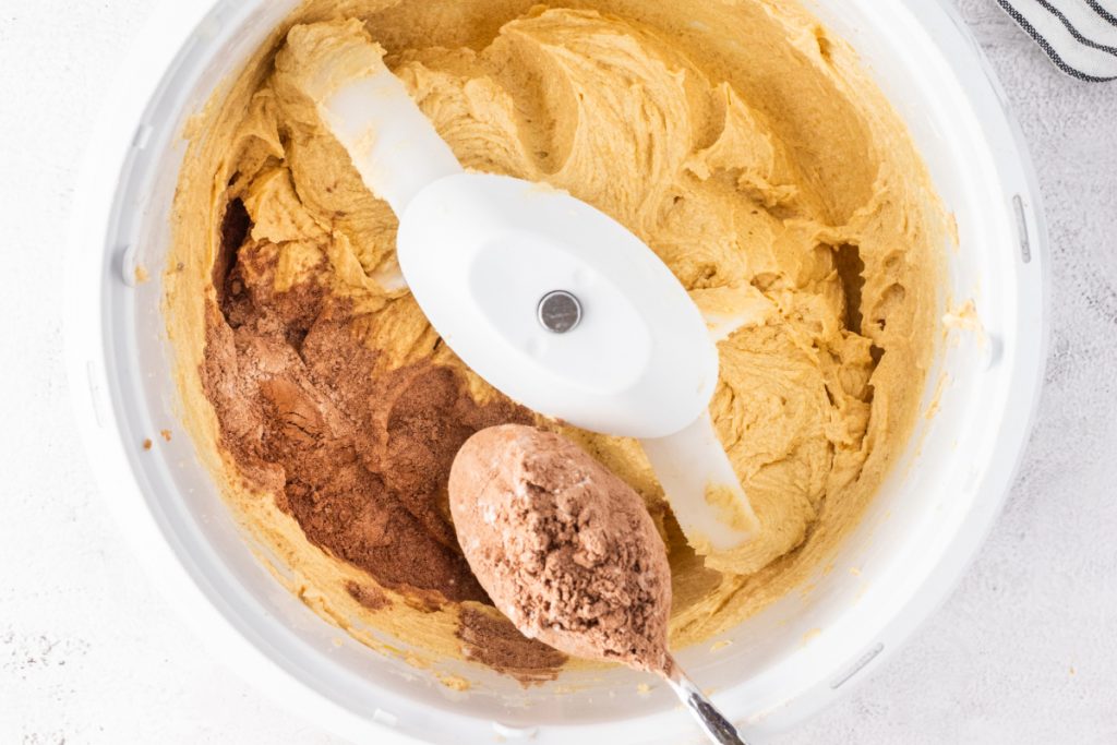 Adding dy ingredients into wet batter ingredients in a mixing bowl. 
