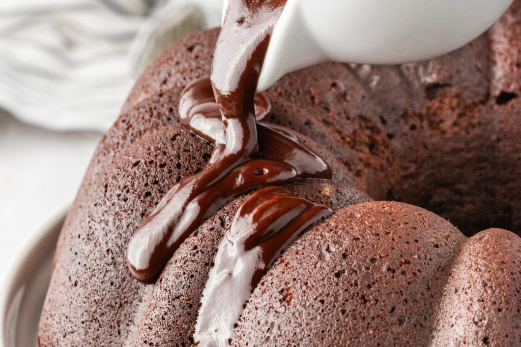 Chocolate ganache poured over cake. 