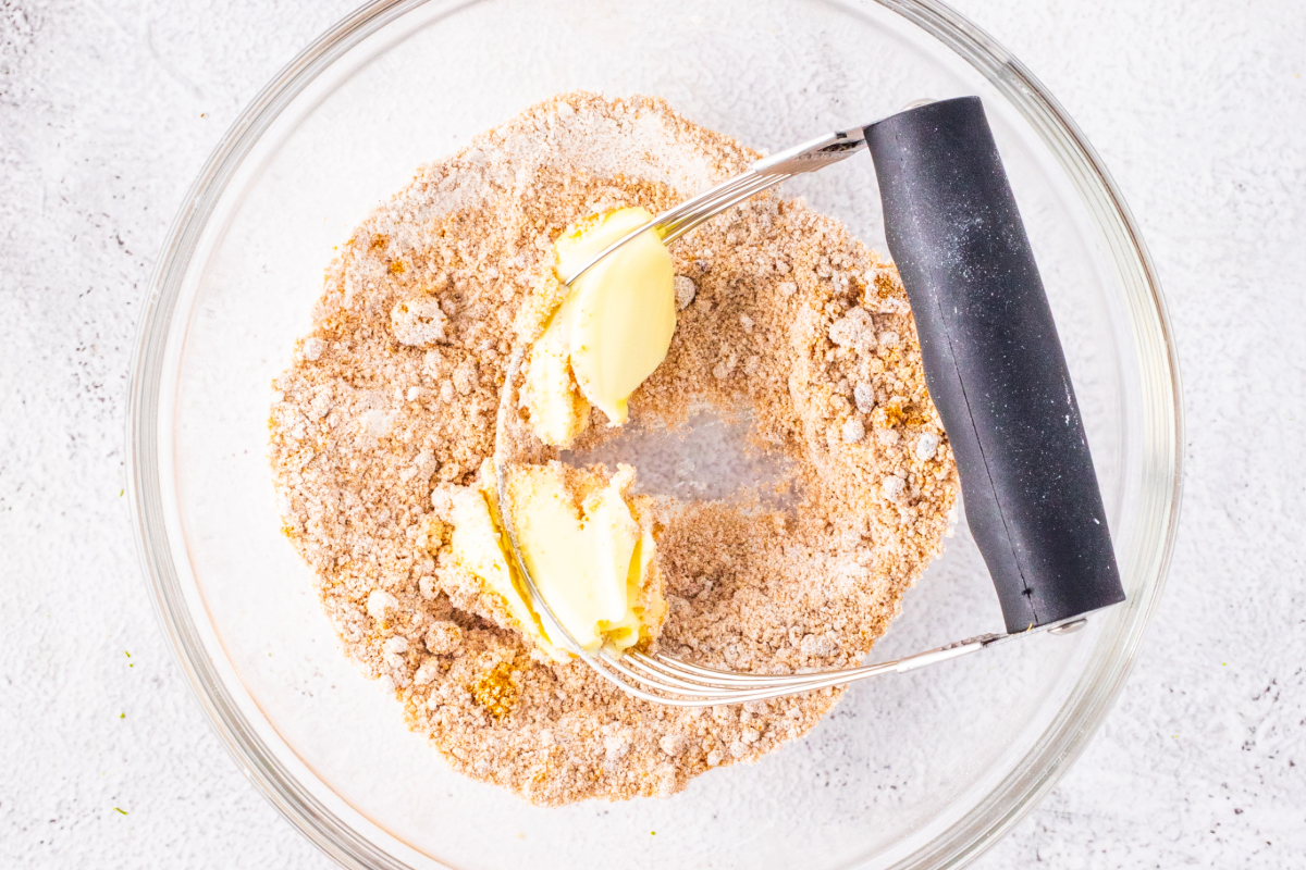 Mixing streusel topping in a clear mixing bowl. 