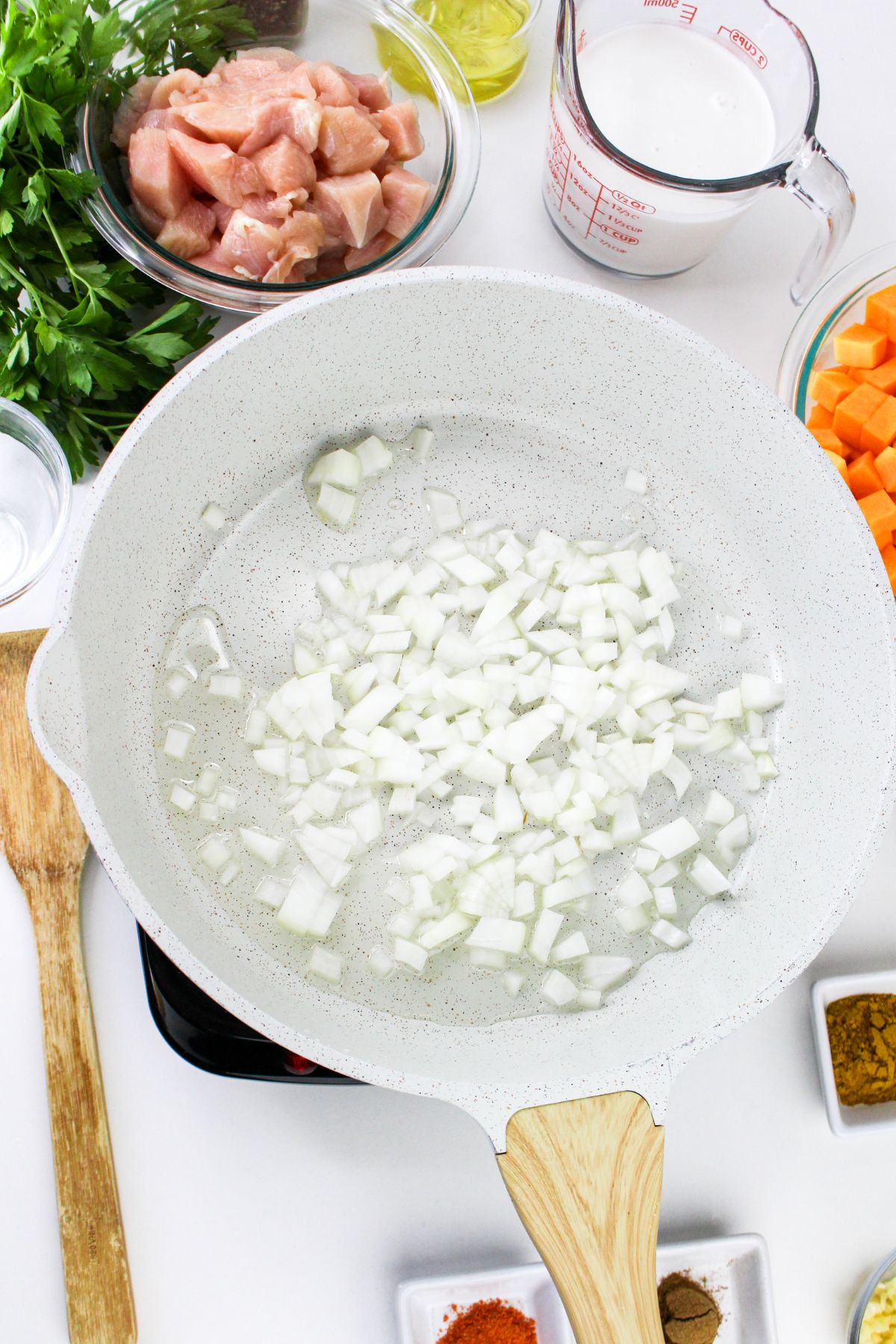 Onions being cooked in a large pot.
