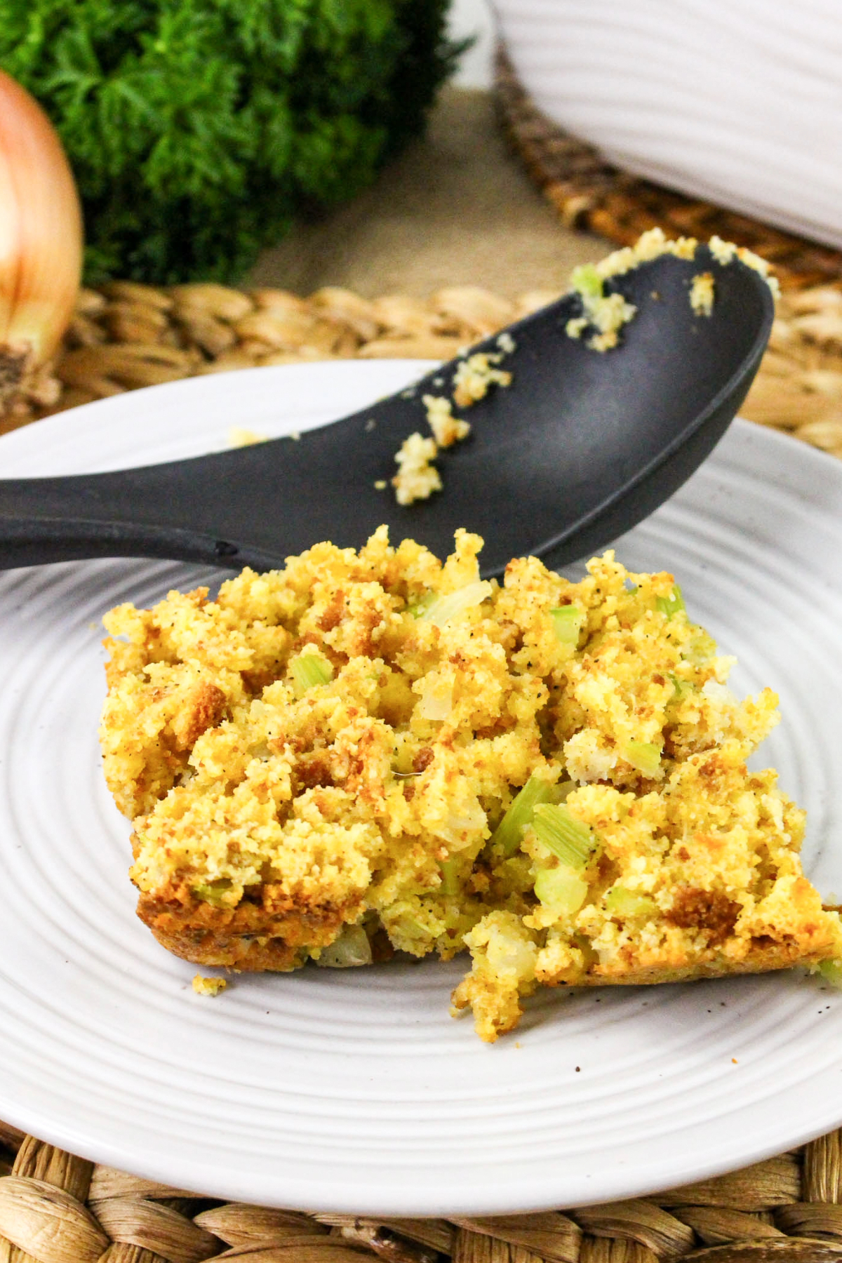 Serving of cornbread dressing on a plate.