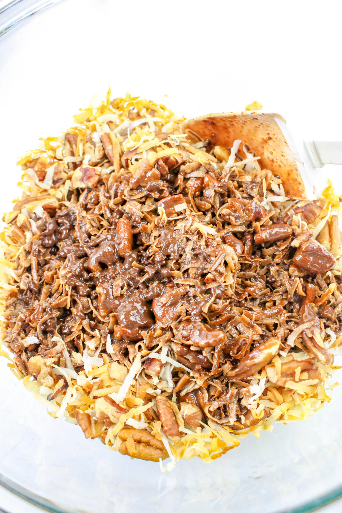 Ingredients being mixed in a glass bowl.