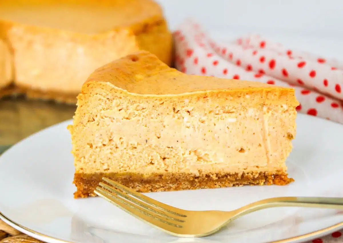Slice of pumpkin cheesecake on a plate.