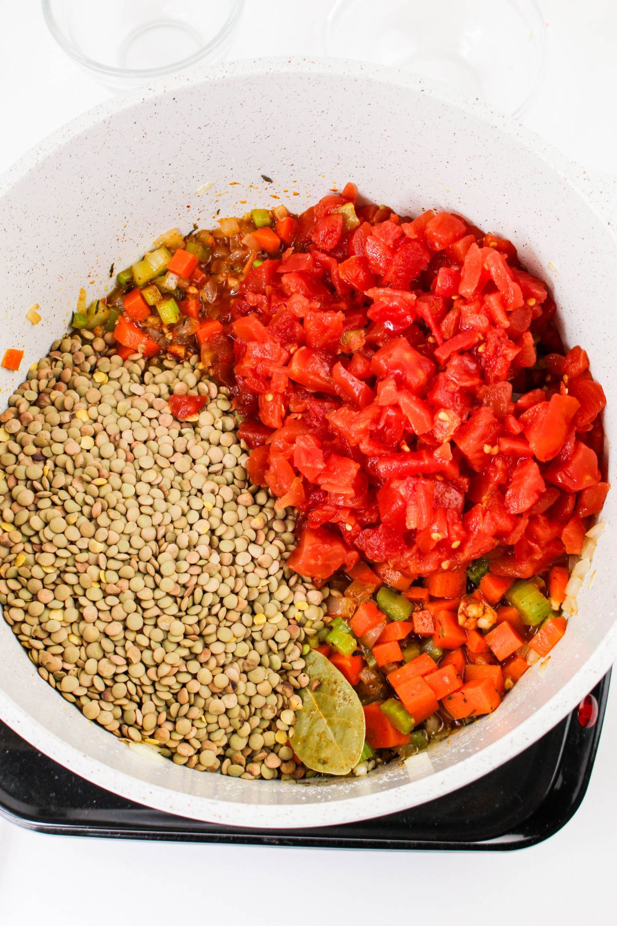 Lentils and tomatoes in a pot.