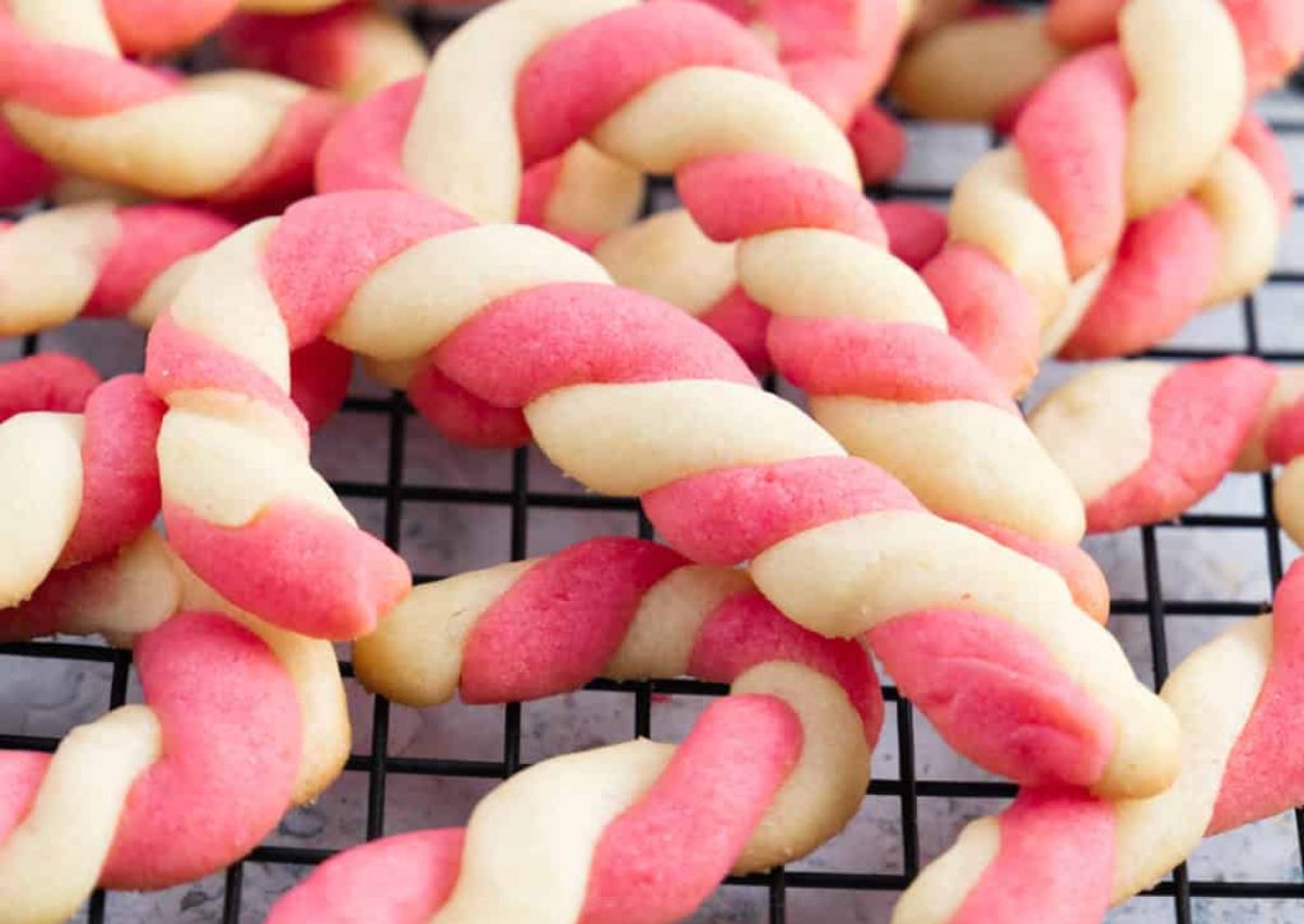 Candy cane cookies on a wire rack.