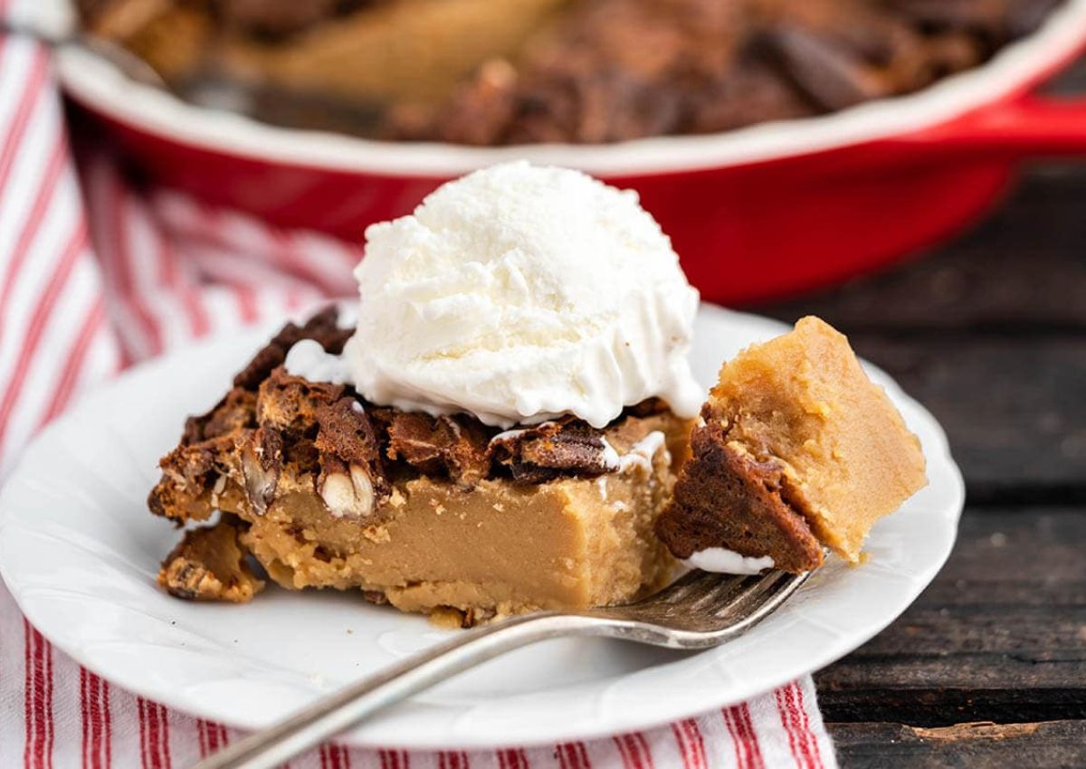 Slice of pecan pie on plate.