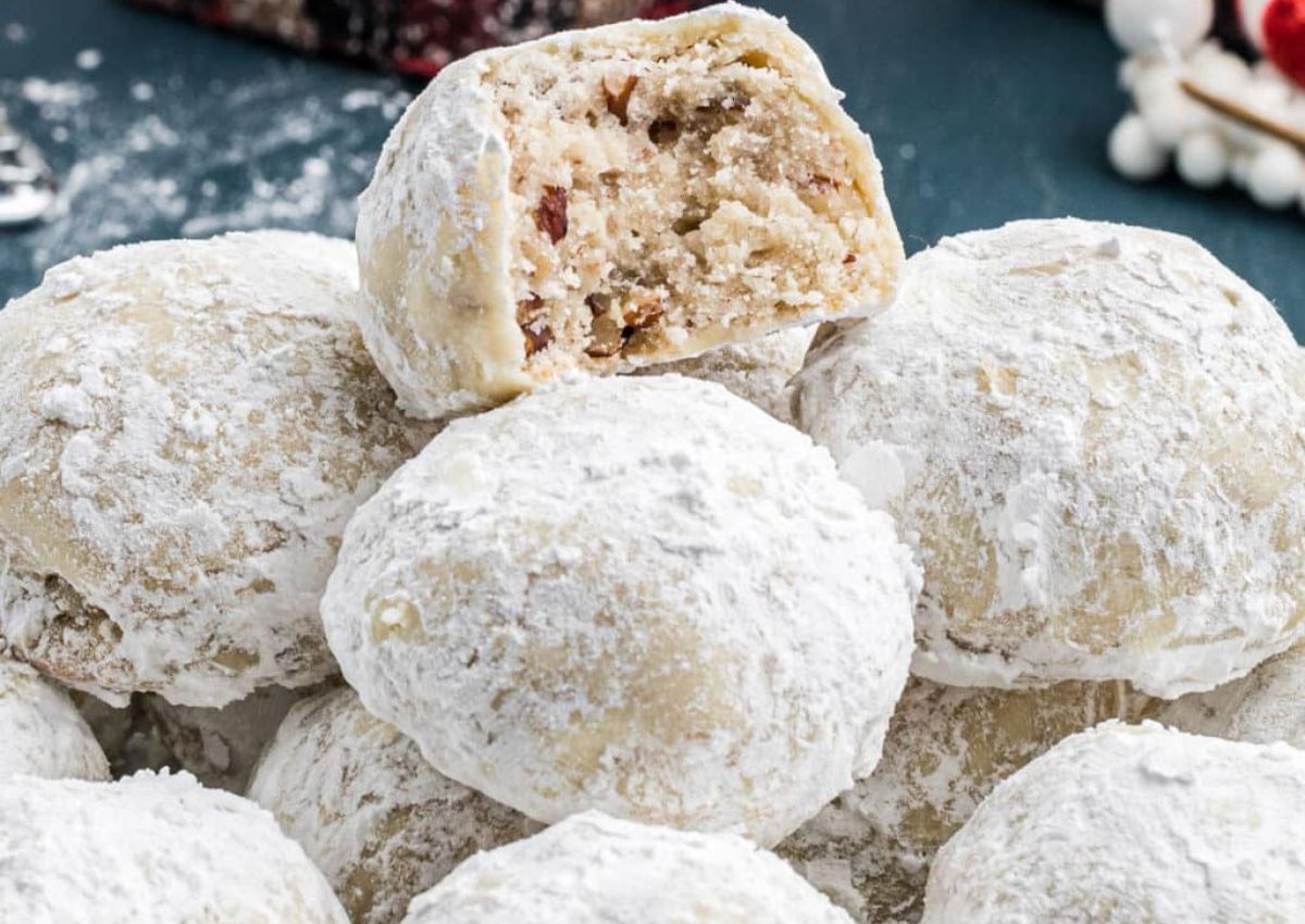 Pecan snowballs cookies stacked on each other.