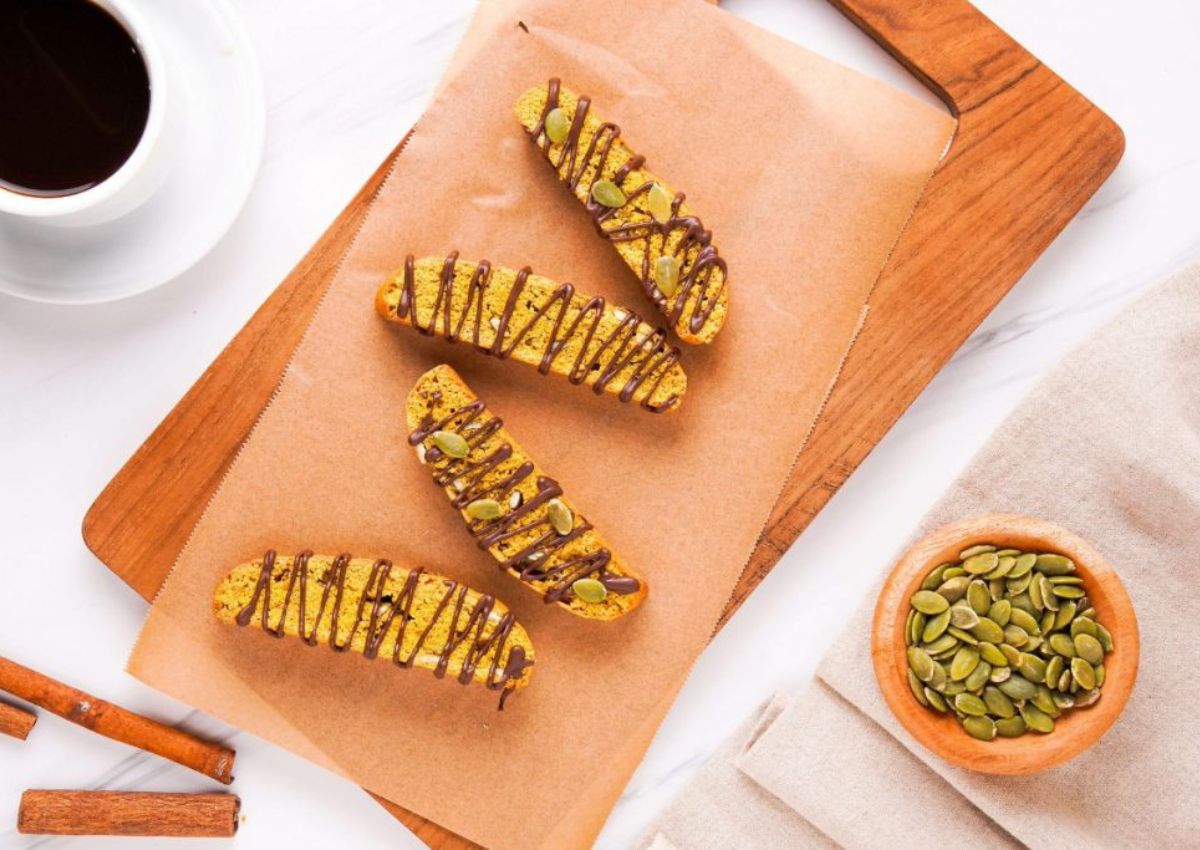 Pieces of pumpkin biscottil on a cutting board.