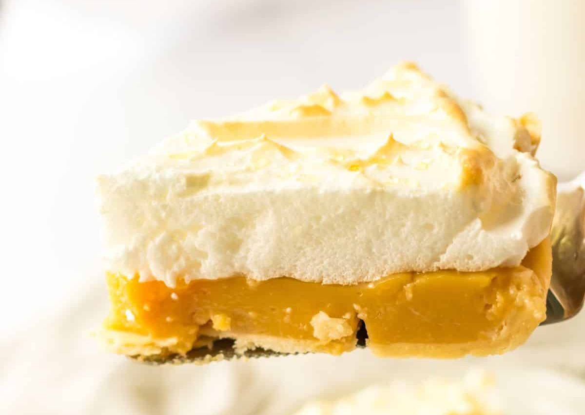 Slice of butterscotch meringue pie on a spatula.