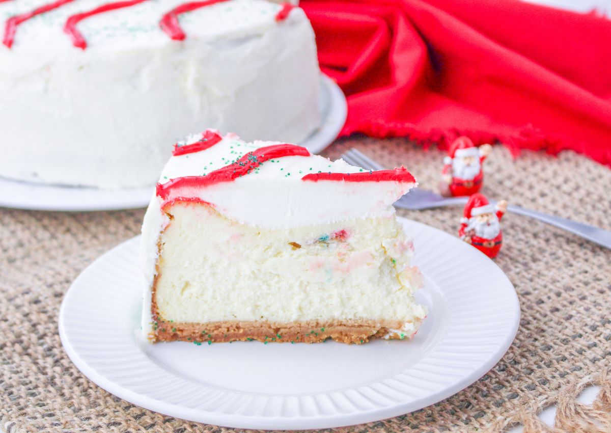 Slice of christmas tree cake cheesecake on a small plate.