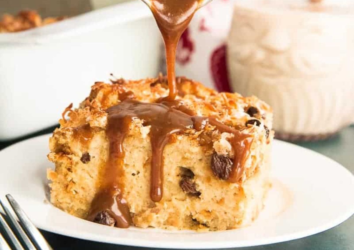 Slice of coquito bread pudding on a small plate.