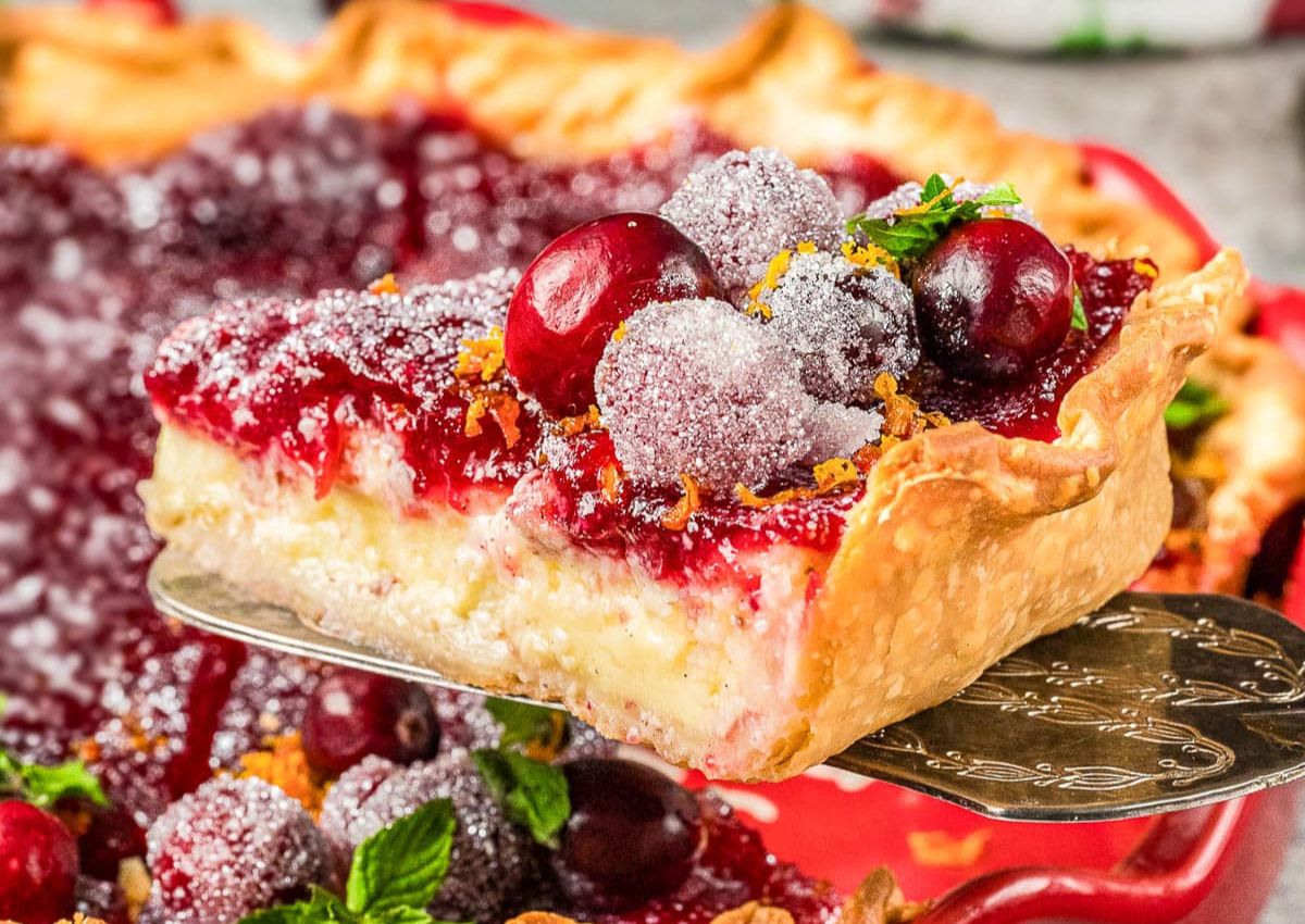 Slice of cranberry custard pie on a spatula.