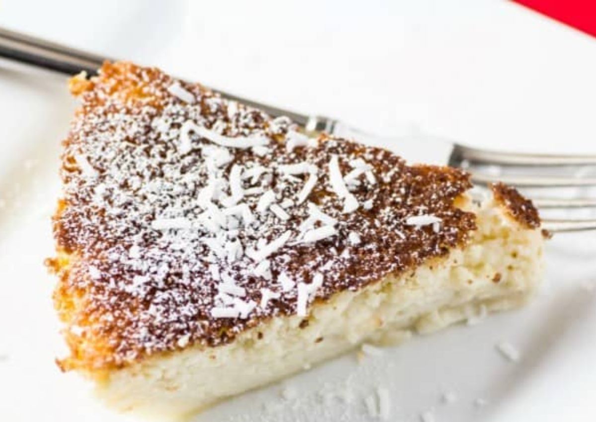 Slice of impossible coconut rum pie on a plate.