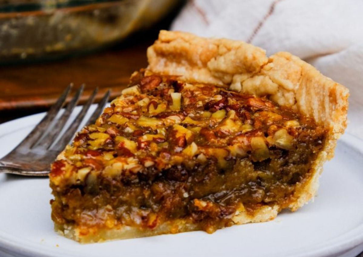 Slice of pecan pie on a plate.