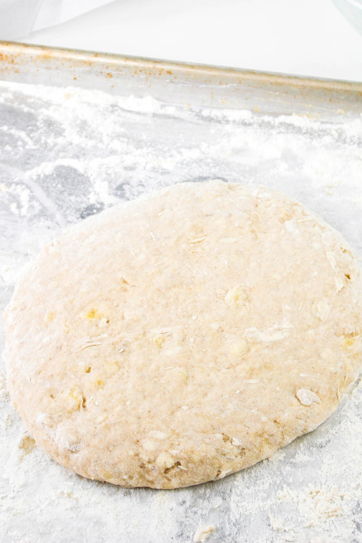 Round shaped scones dough on lightly floured surface.