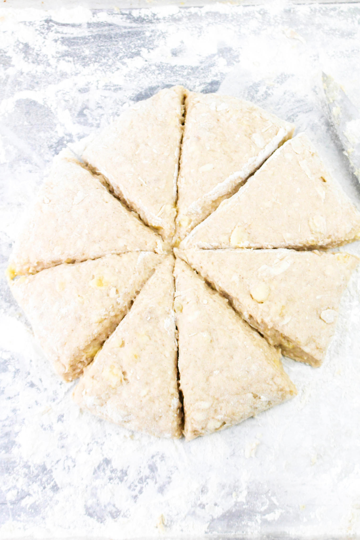 Scones dough in a shape of a circle and cut into triangles before baking.