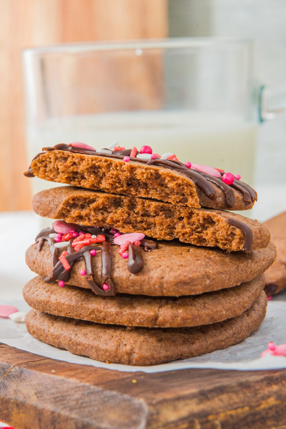 A small tower of chocolate heart shaped cut out cookies the the top one cut in half.