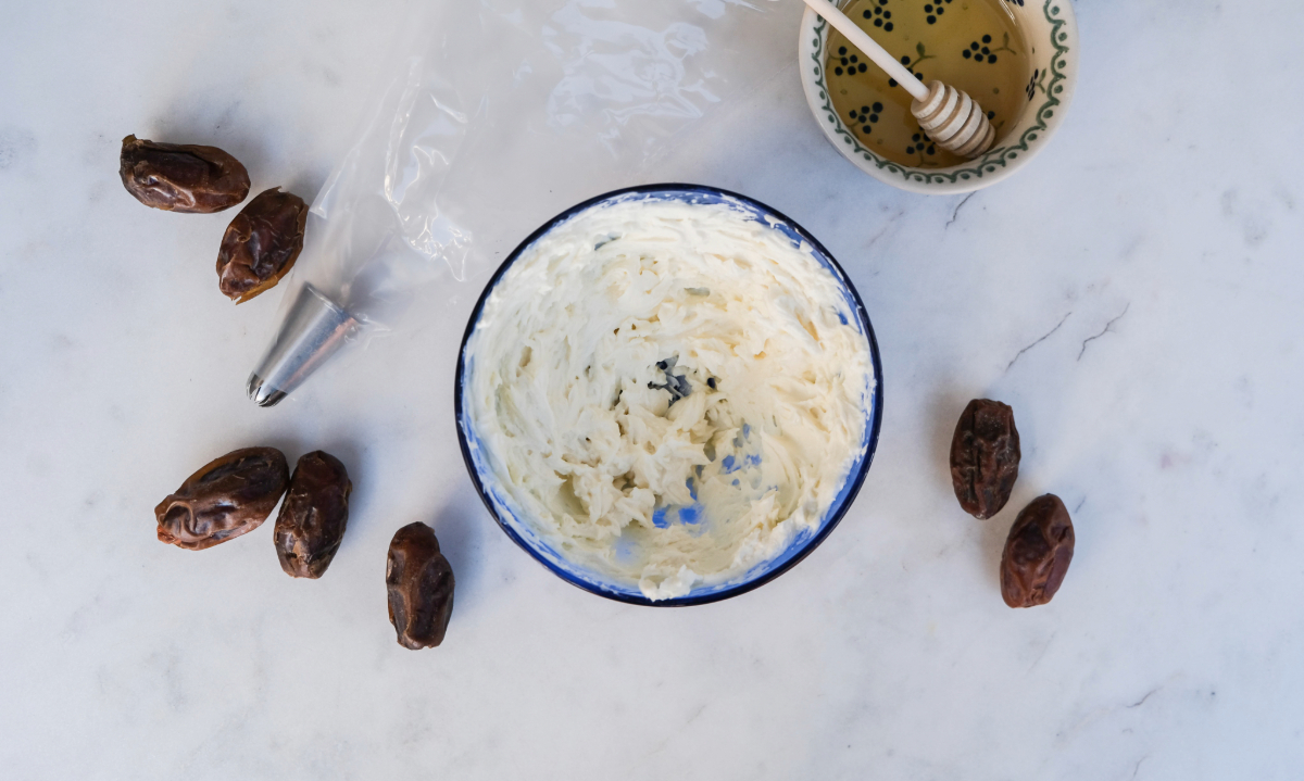 A small blue mixing bowl with creamed goat cheese.