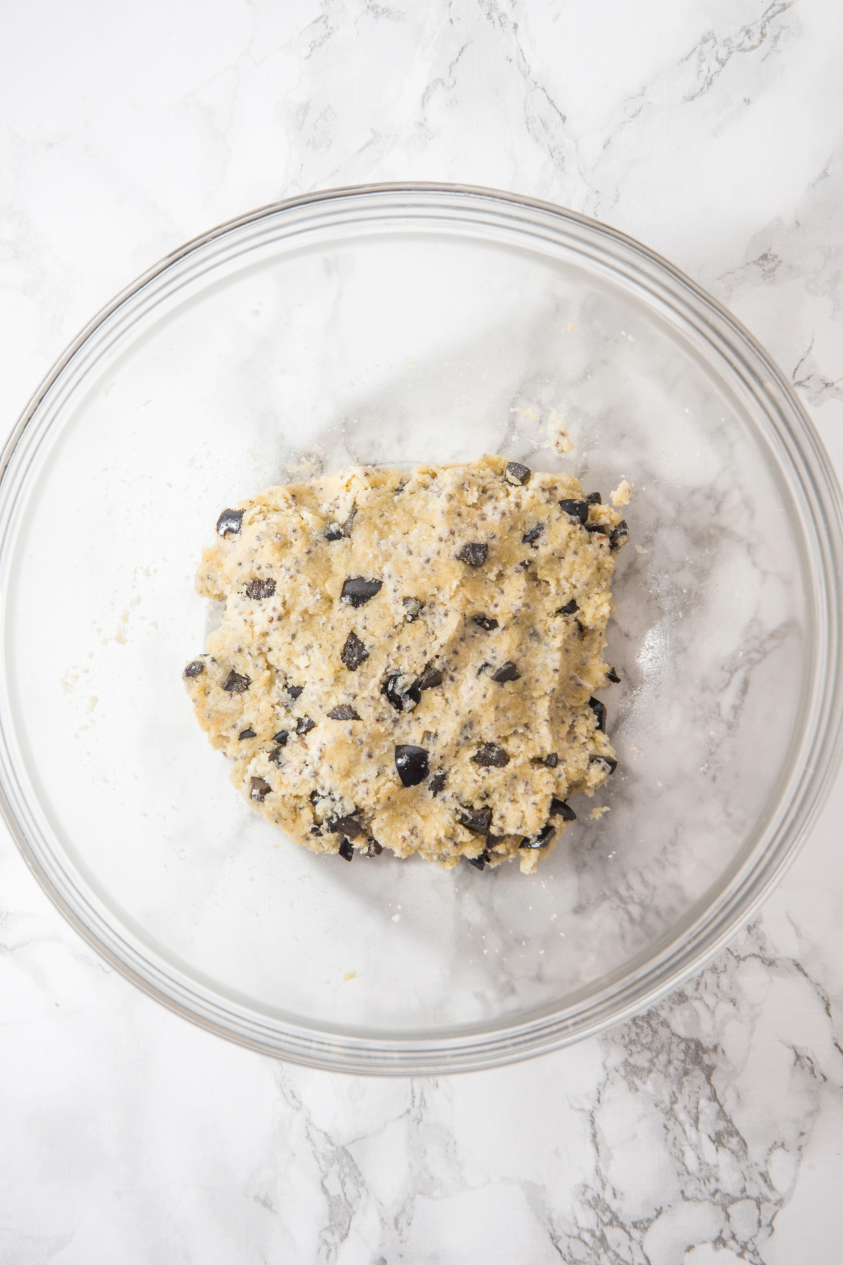 Dough recipe in a mixing bowl before rolling and shaping crackers.