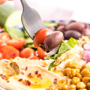 Mediterranean Bowl with a forkful of salad with chickpeas on the side.