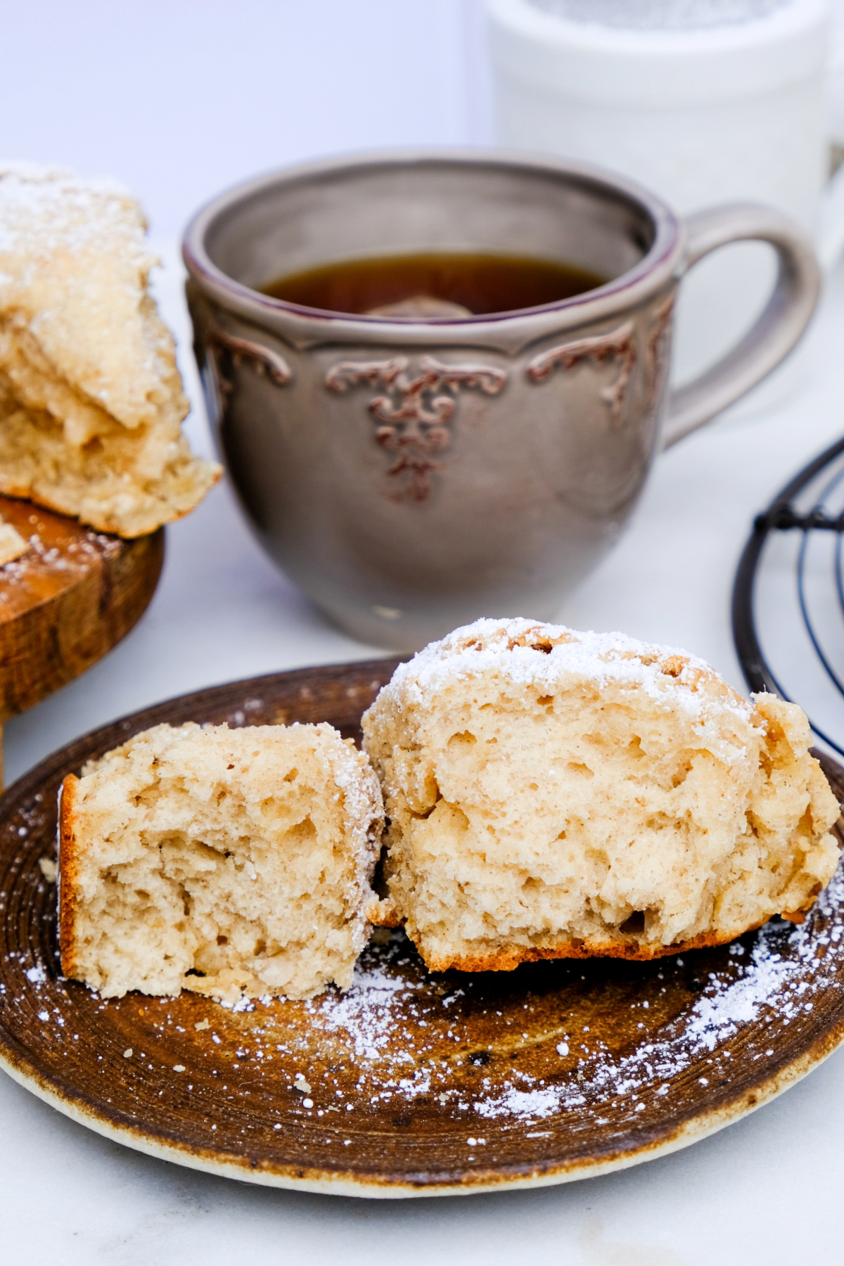 A banana scone cut in half exposing the center on small tan plate.