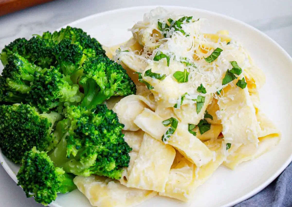 Cottage cheese alfredo on plate with broccoli.