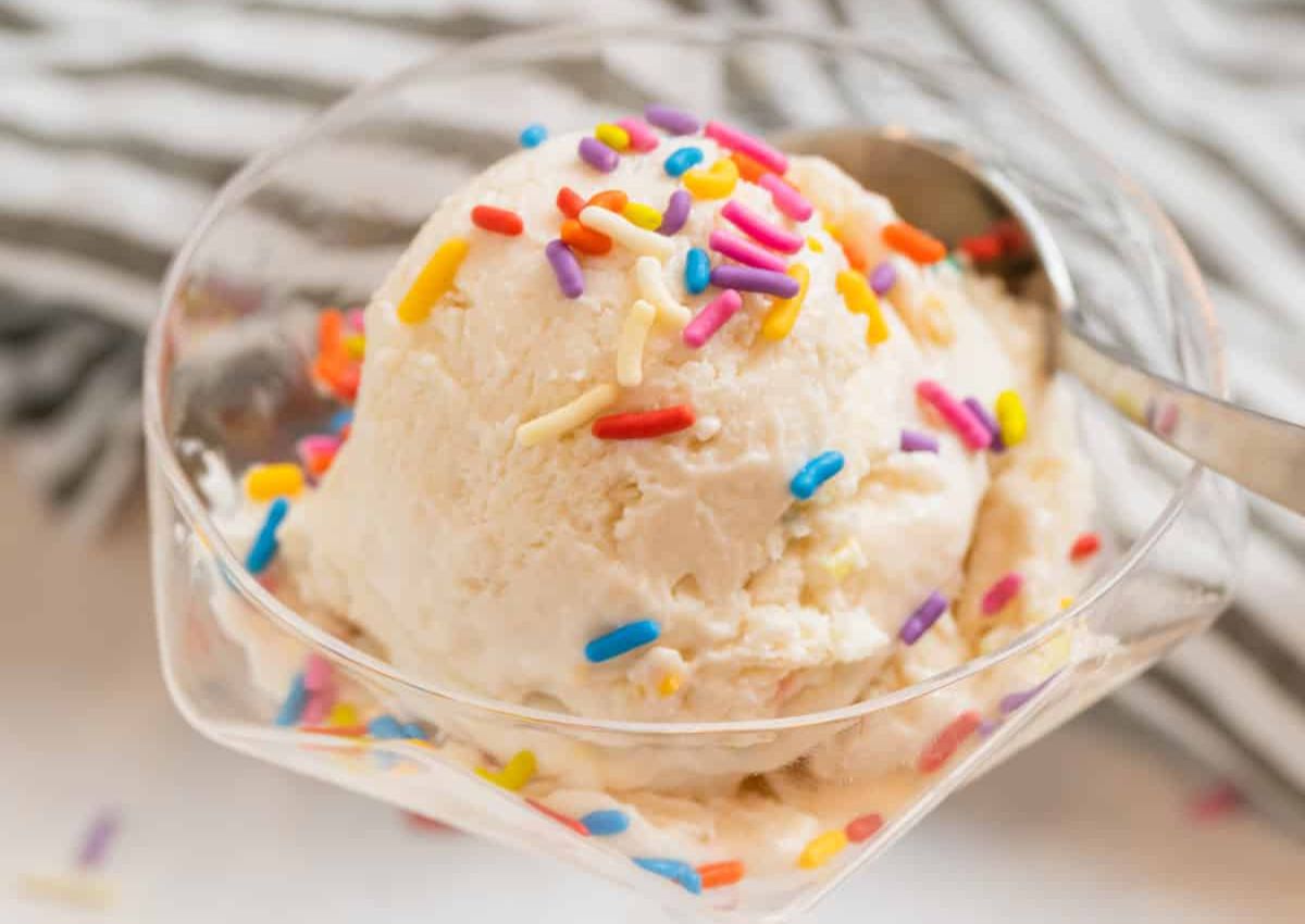 Scoop of cottage cheese ice cream in a bowl topped with sprinkles.