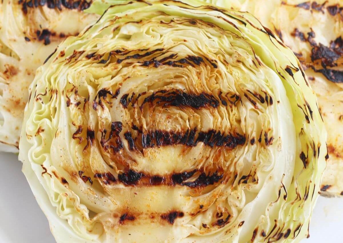 Grilled cabbage steaks on a plate.