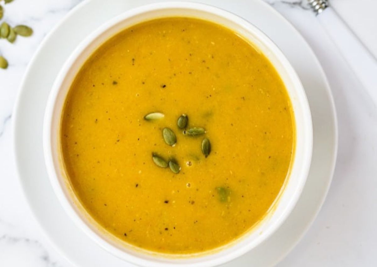 White bowl filled with butternut squash soup.