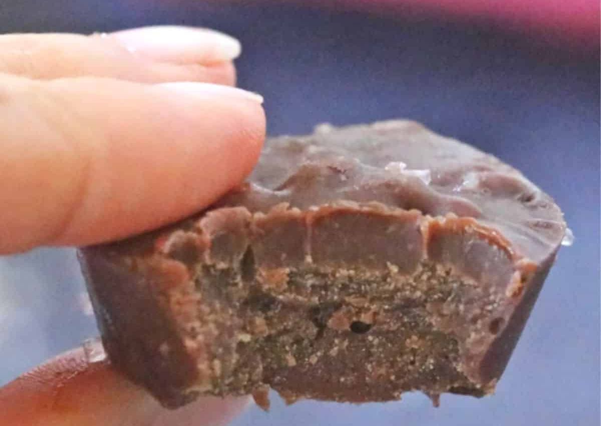 Piece of keto fudge held in a woman's hand.