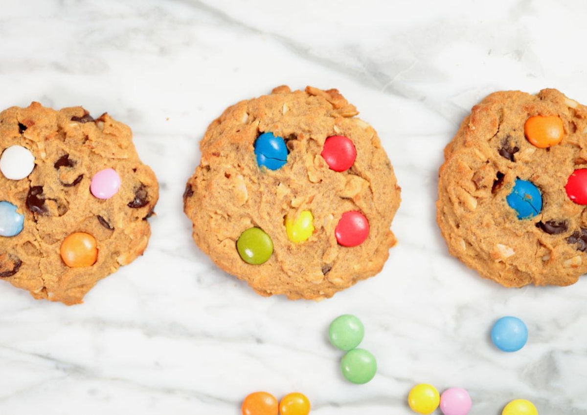 Three keto monster cookies on a table.