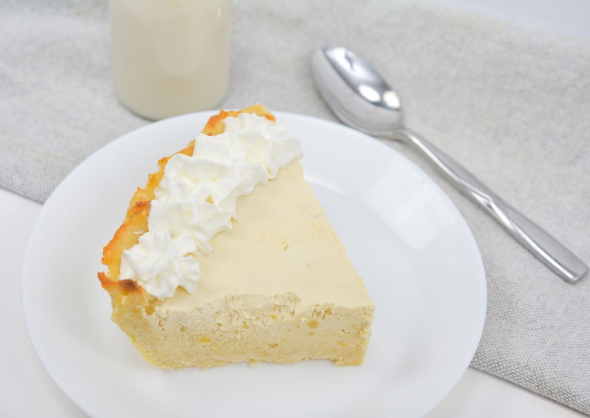 Slice of root beer float pie on a plate.