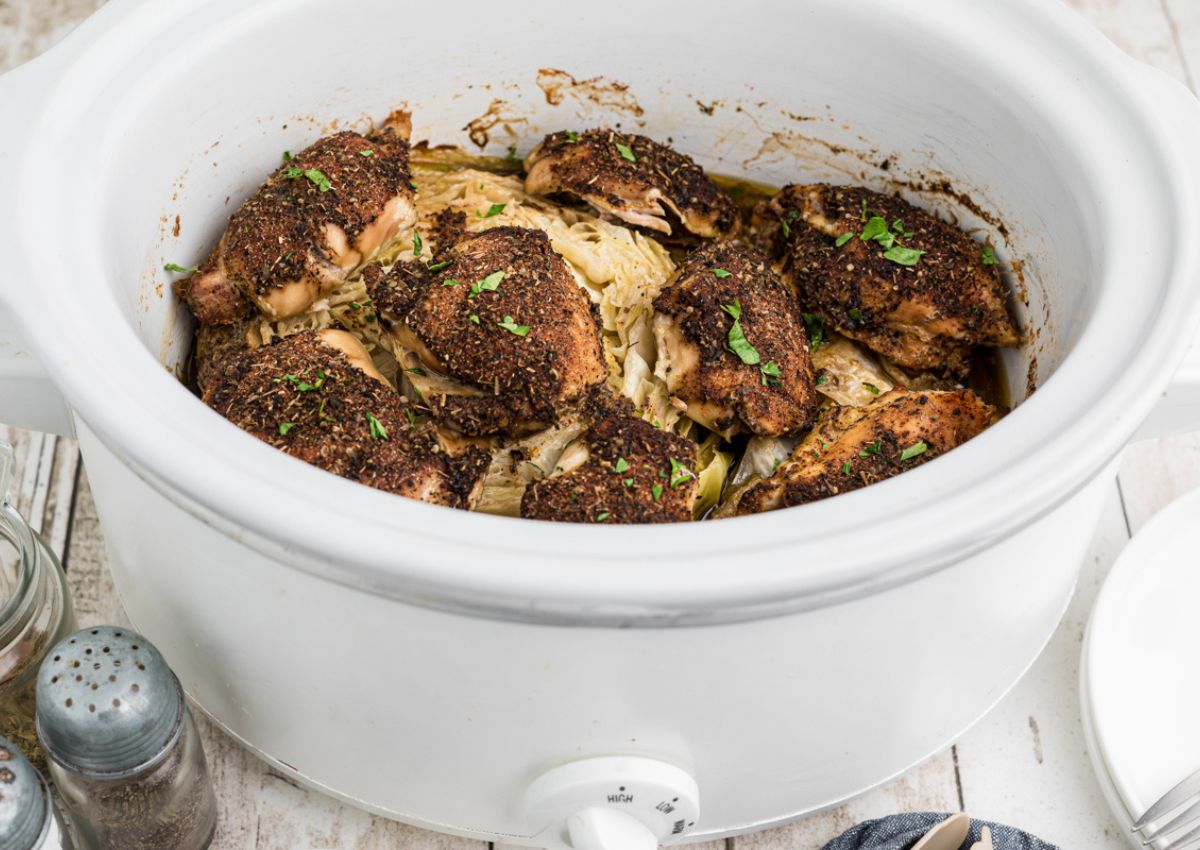 Slow cooker full of chicken and cabbage.