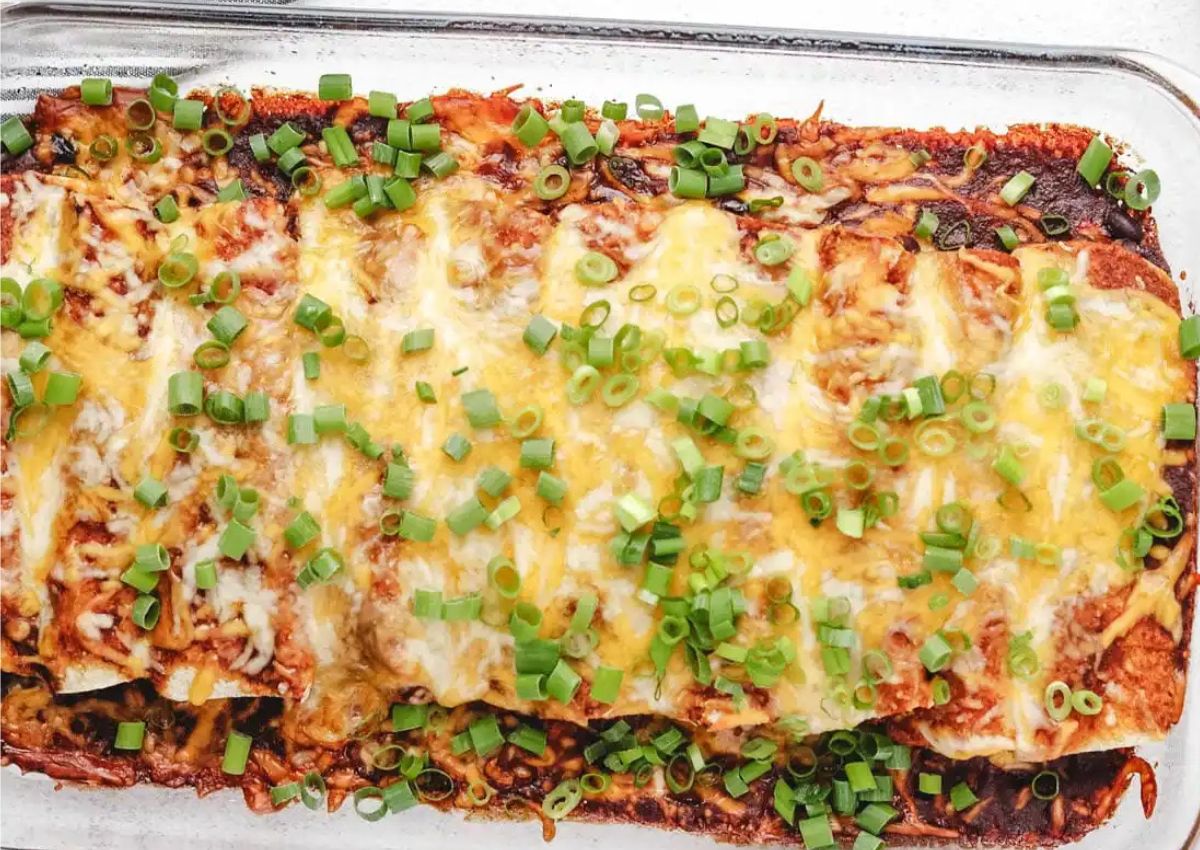 Casserole dish filled with butternut squash black bean enchiladas.