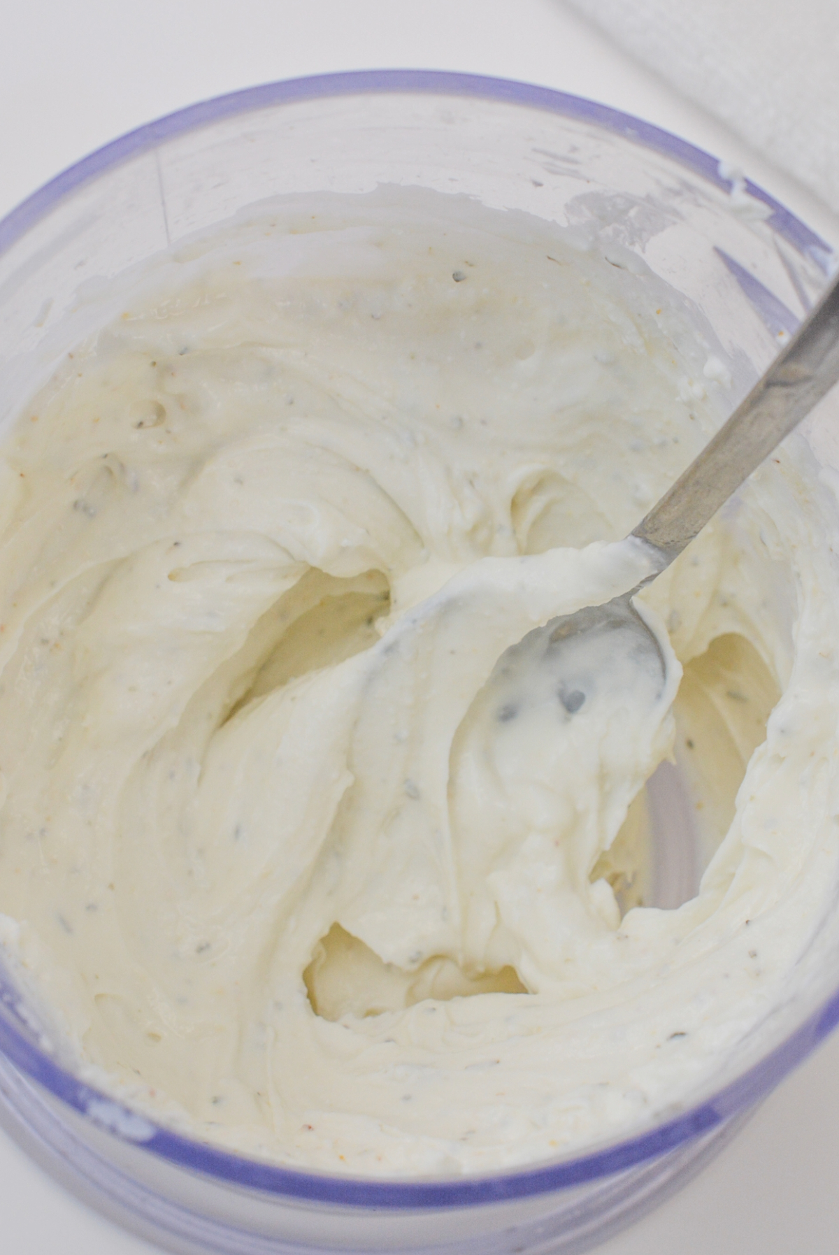 Goat cheese mixed with spices in a food processor.