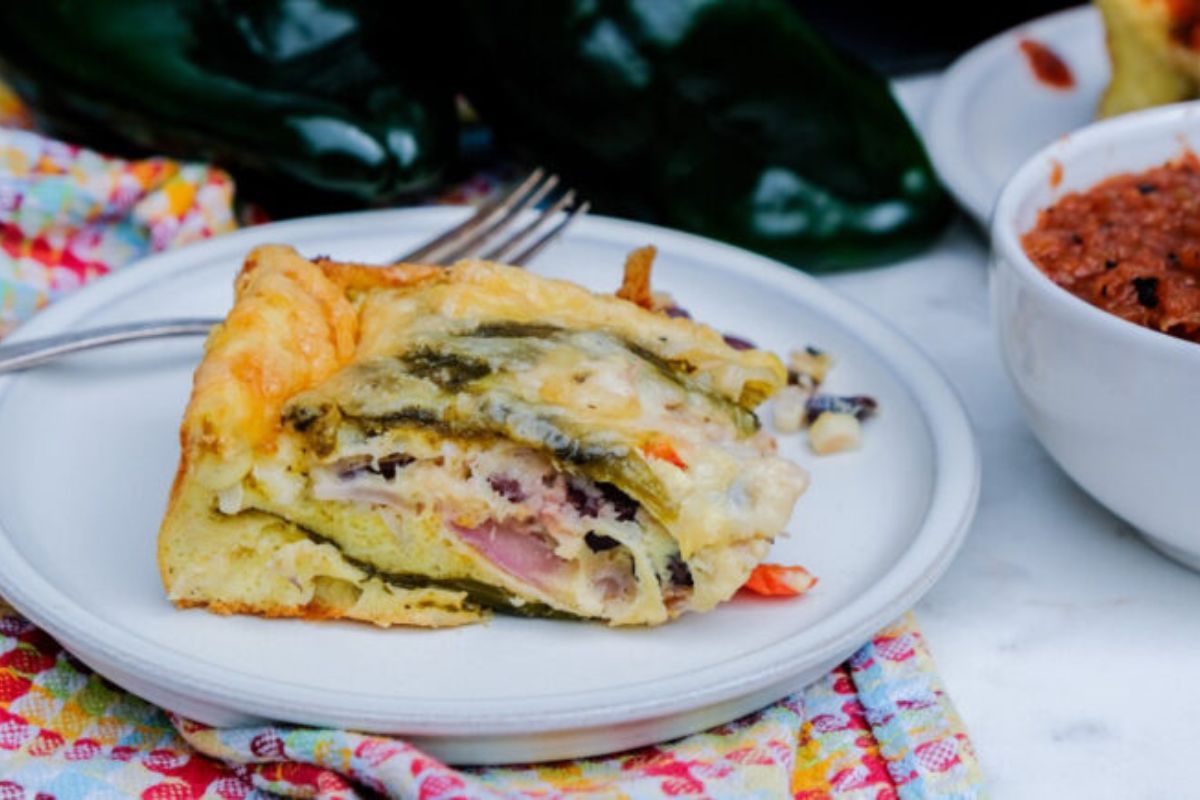 Slice of chiles rellenos casserole on a white plate.