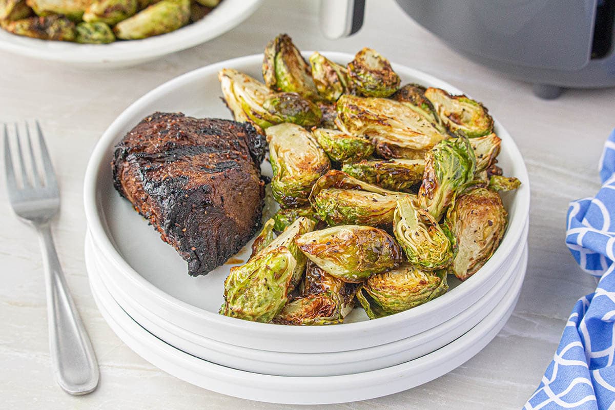 Plate with steak and air fryer brussels sprouts. 