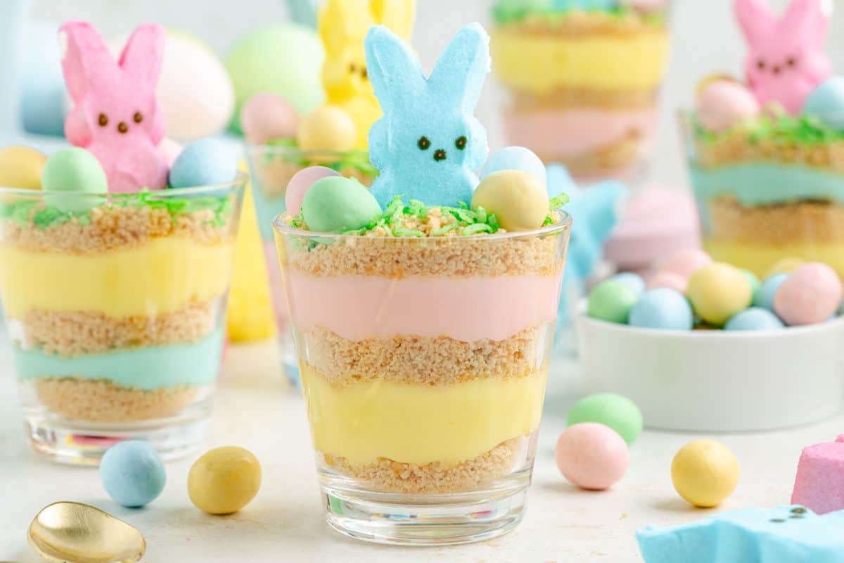 Glass cup filled with layers of pudding and graham crackers and decorated with a peep.