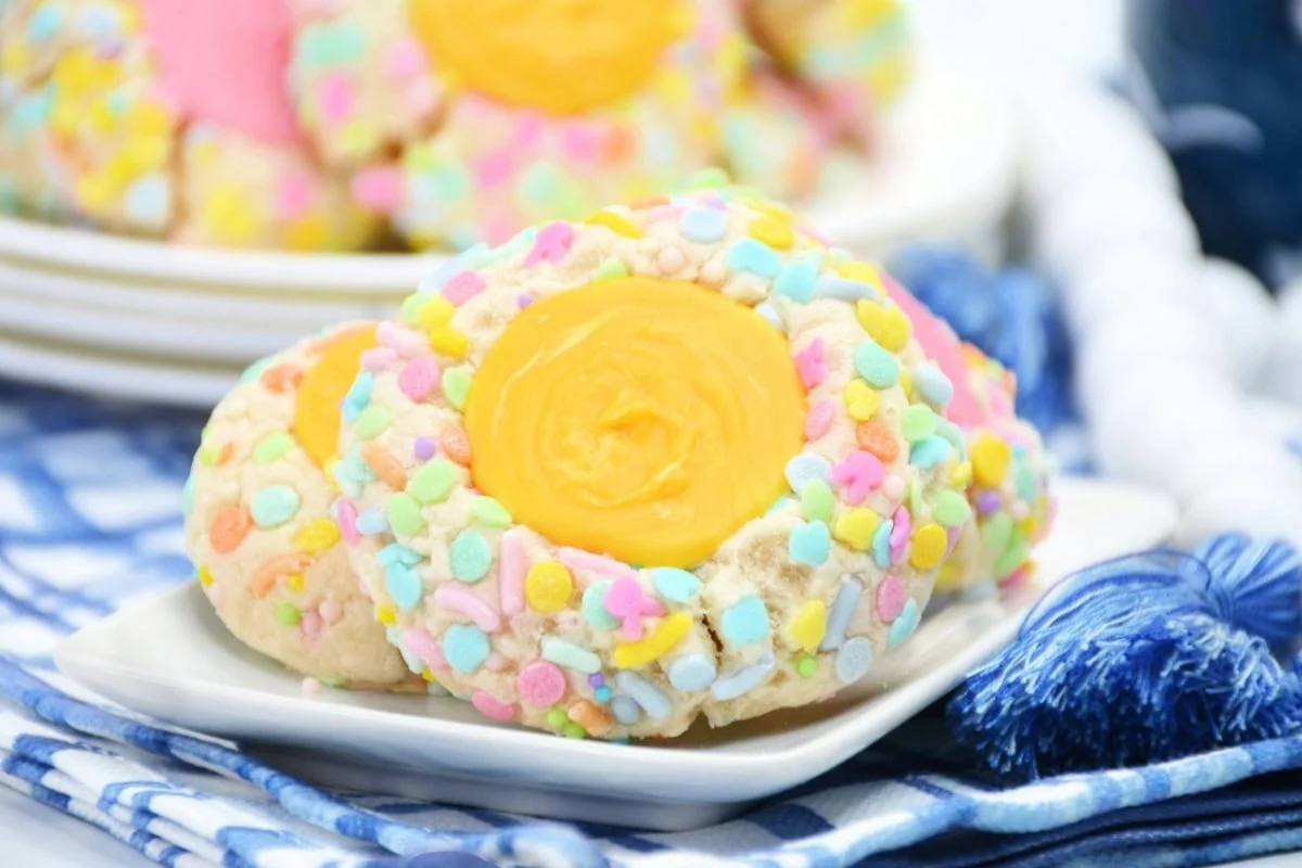 Easter thumbprint cookies on a small plate.