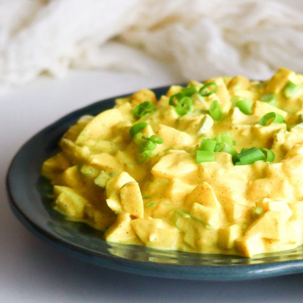 German egg salad on a dark plate.