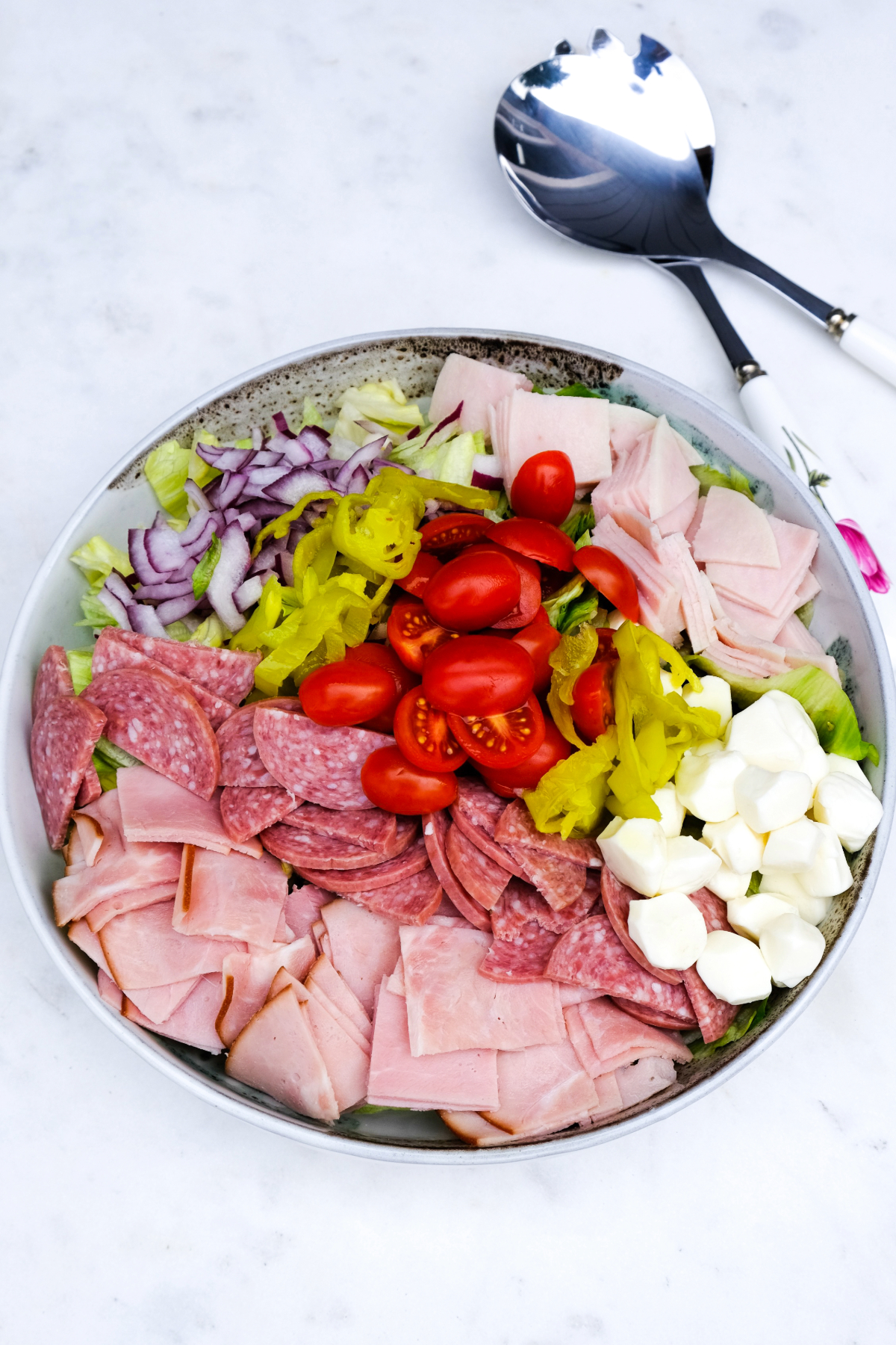 Chopped ingredients in a large salad bowl before adding dressing and tossing.